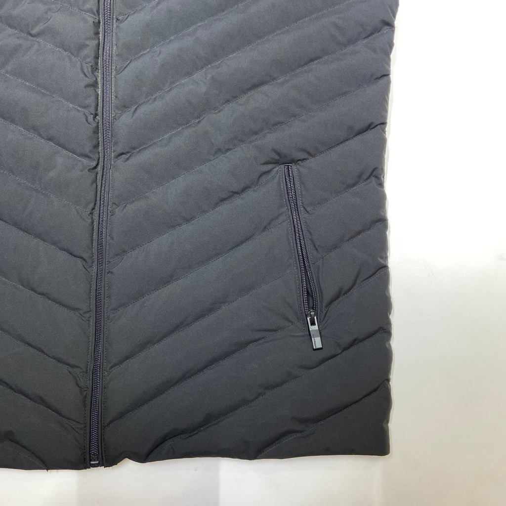 Black quilted jacket with a zipper on a white background