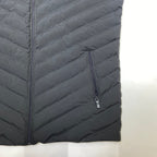 Black quilted jacket with a zipper on a white background